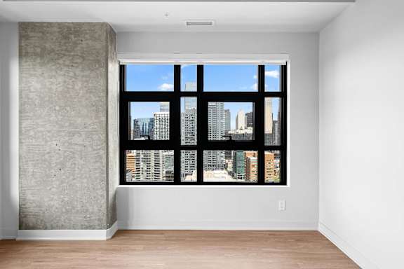 A large window with a view of a city skyline.