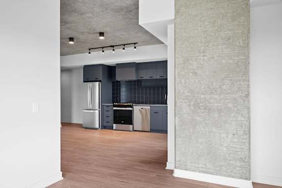 A kitchen with a stainless steel refrigerator, oven, and dishwasher.