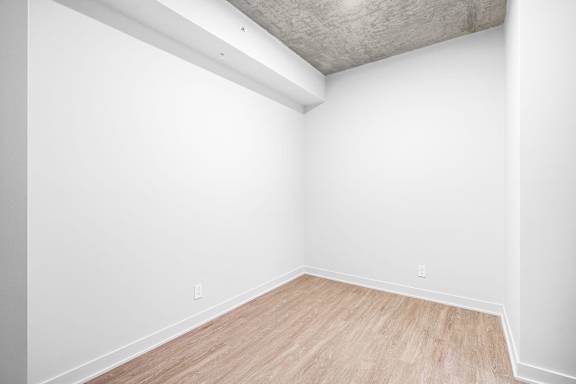 A room with white walls and wooden flooring.