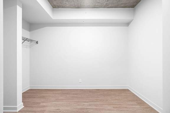 Empty room with wooden floor and white walls.