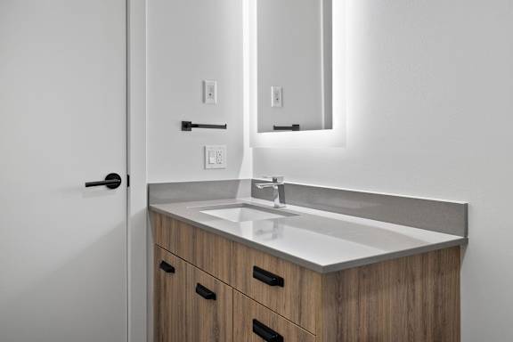 A bathroom with a sink and a mirror.
