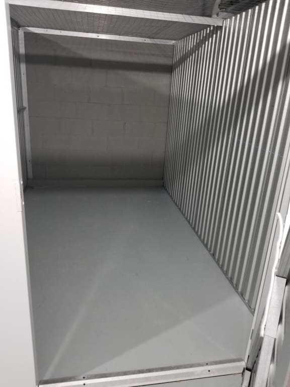 the inside of a prison cell with the door open