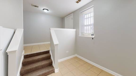 A room with a staircase leading to the second floor.