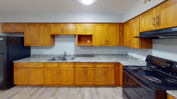 a kitchen with wood cabinets and granite countertops