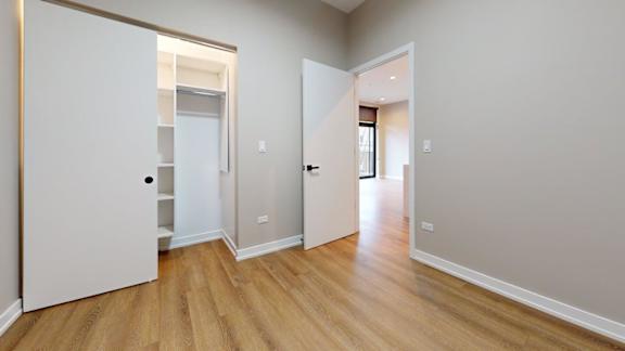 A room with a white door and a white wall.