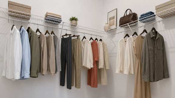 A row of clothes hanging on a rack.