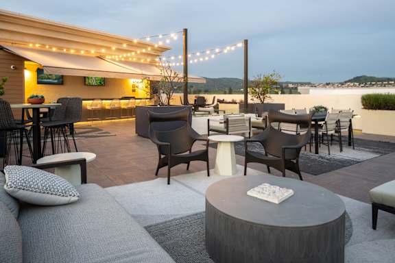 A patio with a table and chairs is set up for an evening of relaxation.