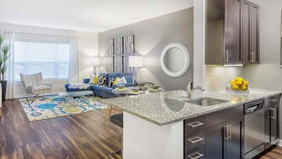 A modern kitchen with a large island and stainless steel appliances.