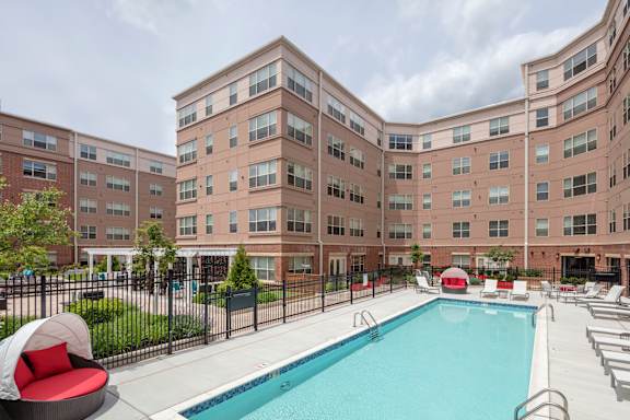 A large building with a pool in front.