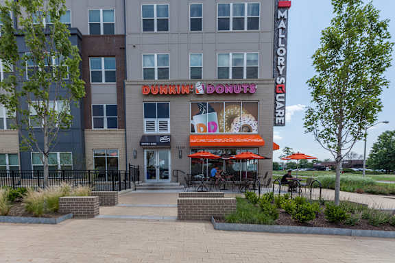 A Dunkin' Donuts store is located in a shopping center.
