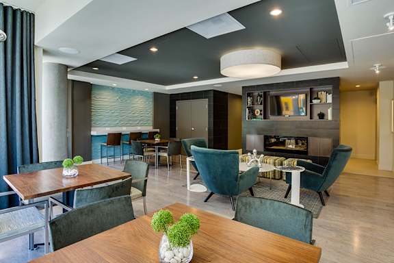A modern dining room with a wooden table and chairs.