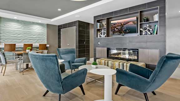A modern living room with a fireplace and a television.