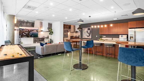 A modern kitchen with a dining table and chairs.