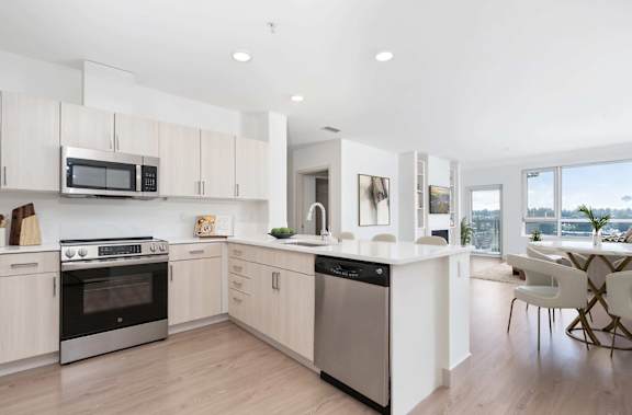 A modern kitchen with a large island and stainless steel appliances.
