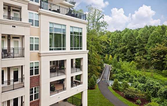 A building with a balcony overlooking a winding road.