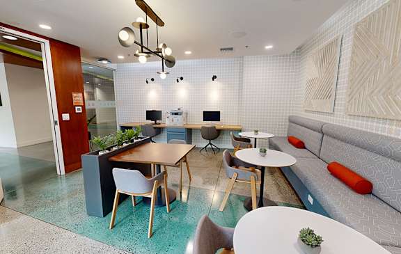 A modern dining area with a glass table and chairs.