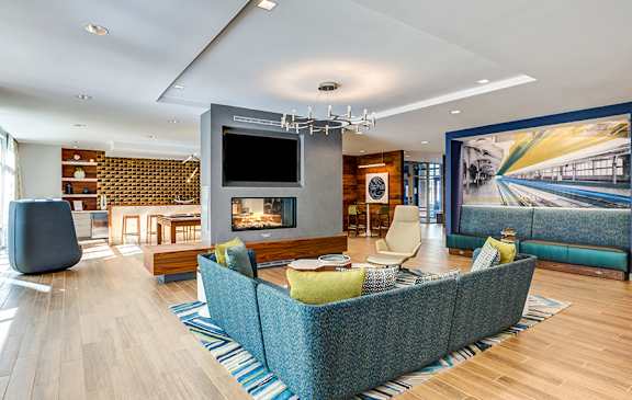 A modern living room with a large sofa and a television.