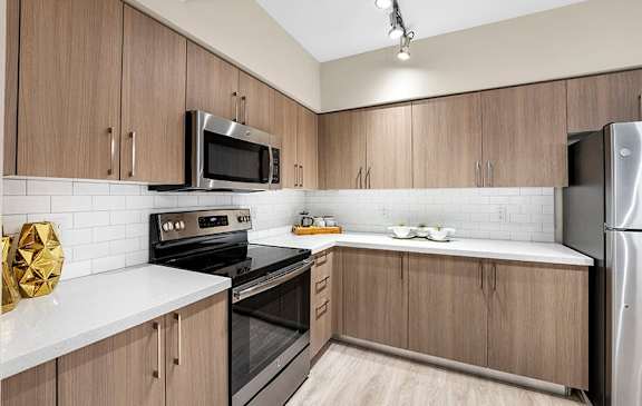 A kitchen with wooden cabinets and a white countertop.