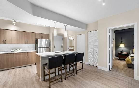 A modern kitchen with a dining table and chairs.