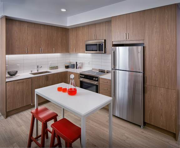 A modern kitchen with a table and chairs.