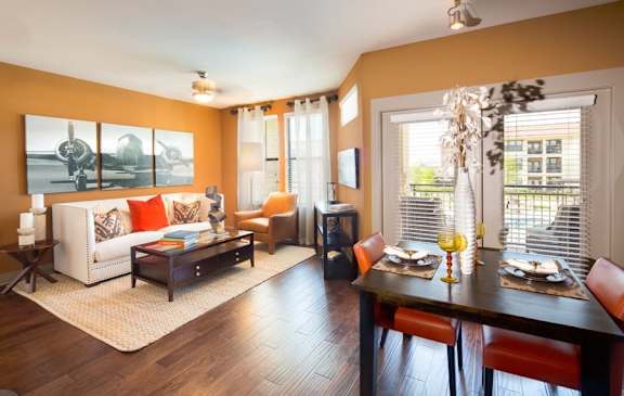 A dining room with a wooden table and chairs.