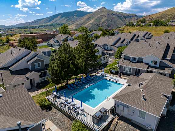 an aerial view of a swimming pool with houses in the background