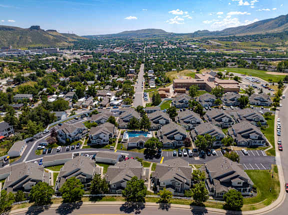 an aerial view of a neighborhood of houses with cars parked