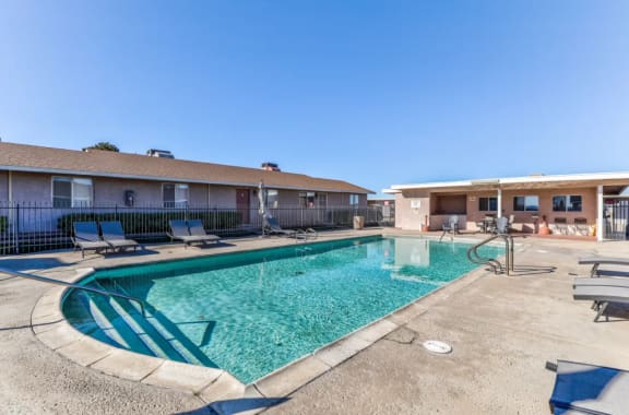 our apartments have a resort style pool with lounge chairs at Aspire Seneca, Victorville, California