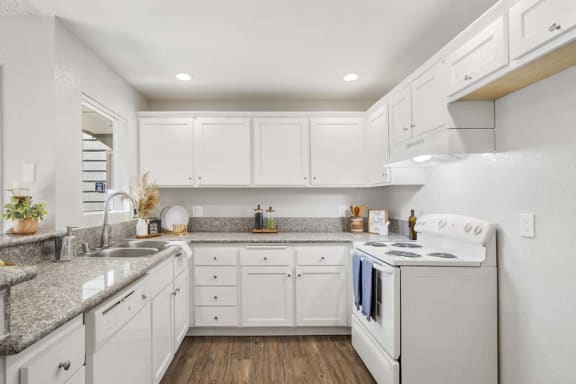 a kitchen with a stove top oven next to a sink at Aspire Rialto, California