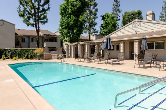 our apartments have a resort style pool with chairs and umbrellasat Aspire Rialto, Rialto, CA