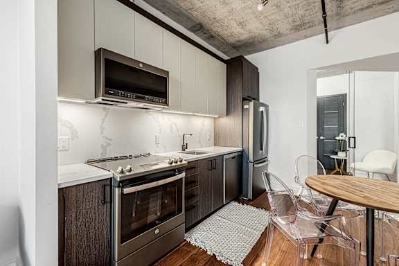 a kitchen with stainless steel appliances and a dining table