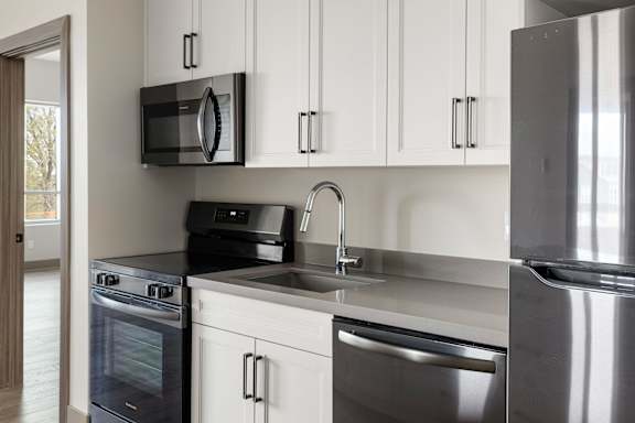 A modern kitchen with a black microwave above the stove.