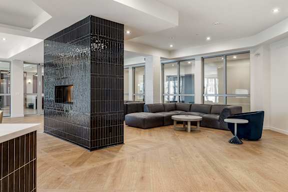 A modern living room with a fireplace and a large couch.