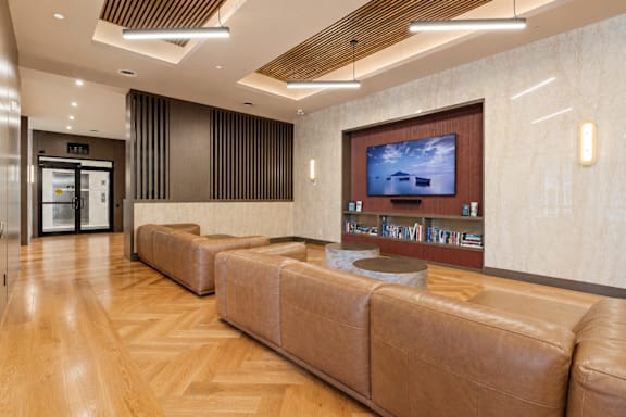 A modern waiting room with a flat screen TV mounted on the wall.