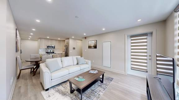 A modern living room with a grey sofa and a coffee table.