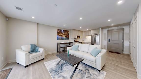 A living room with a white couch and a coffee table.
