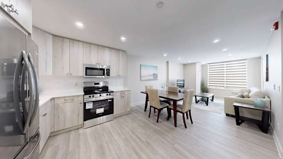 A modern kitchen with a dining table and chairs.