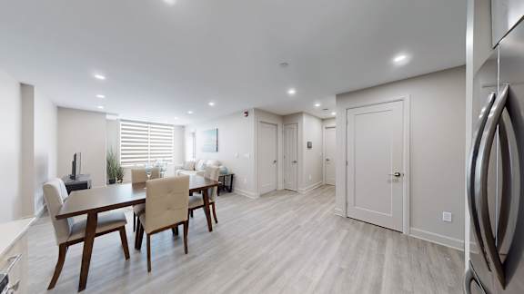 A modern kitchen with a dining table and chairs.