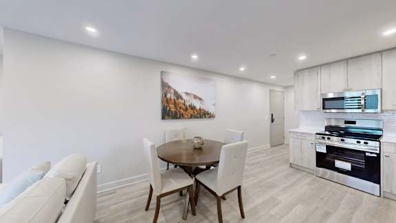 A modern kitchen with a dining table and chairs.
