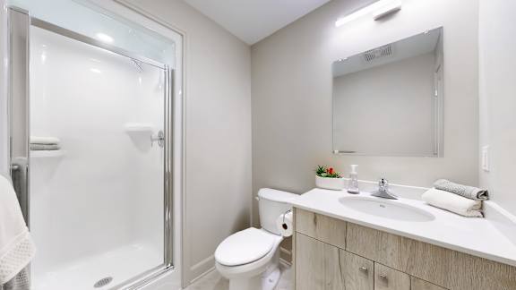 A white toilet sits next to a sink in a bathroom.
