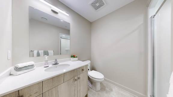 A white bathroom with a toilet and sink.