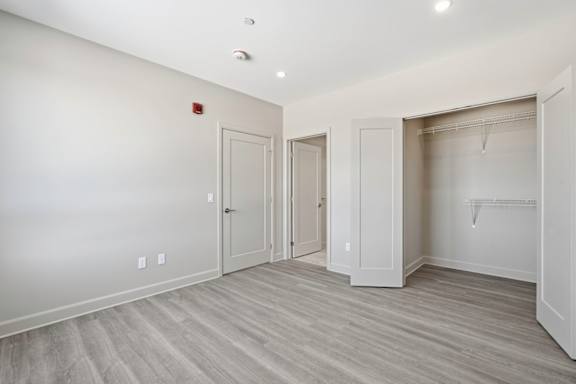 A room with a white wall and a grey floor.