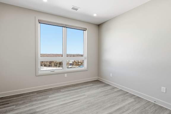 A room with a large window overlooking a snowy landscape.