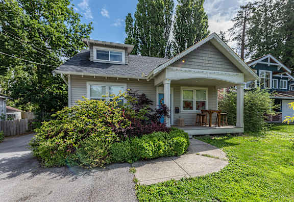 A house with a grey roof and a small porch.