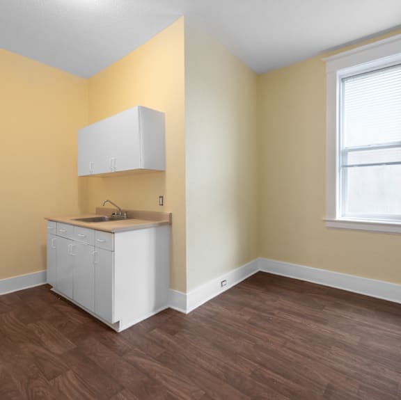 A kitchen with a white cabinet and sink.