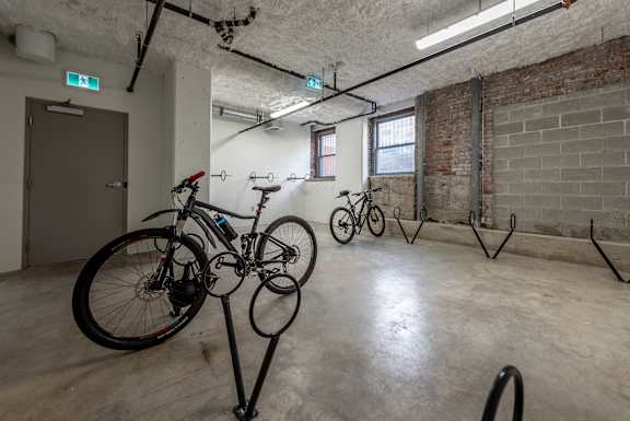 a bike room with bikes on display in a basement