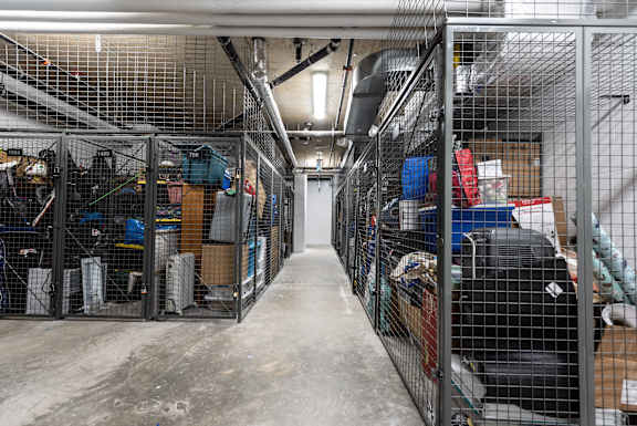 a room filled with cages and boxes in a warehouse