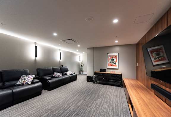 a large living room with leather couches and a tv
