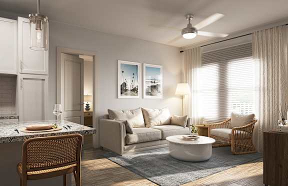 A modern living room with a dining area and a kitchen in the background at Allegra at Cocoa in Cocoa, FL, 32926