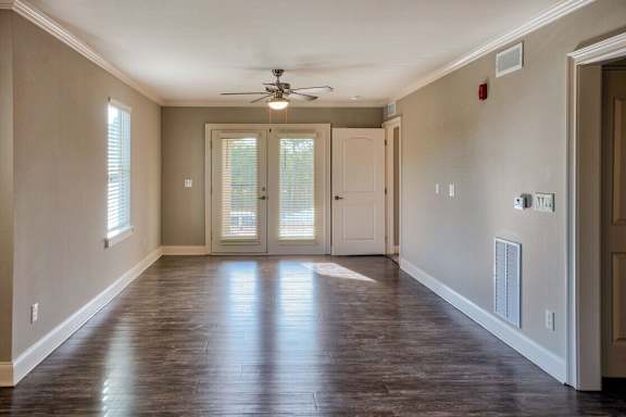 A room with a ceiling fan and sliding glass doors at Mode at Melbourne, LLC Apartments, Florida, 32901